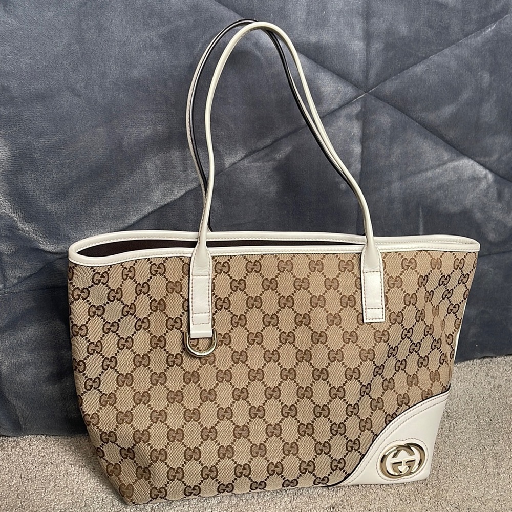 Canvas Gucci tote with white leather accents and handles.